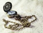 A pocket watch on a paper with quill work illustrates a story about trends in addiction treatment