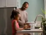 parent and child at a sink illustrates story about parent led-therapy