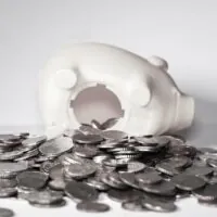 piggy bank spilling coins illustrate digital behavioral health funding environment