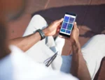 An overhead shot of a person holding a smartphone with the Wysa interface displayed.