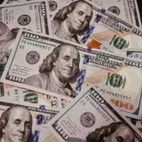 Pile of $100 bills Photo by Jonathan Borba on Unsplash